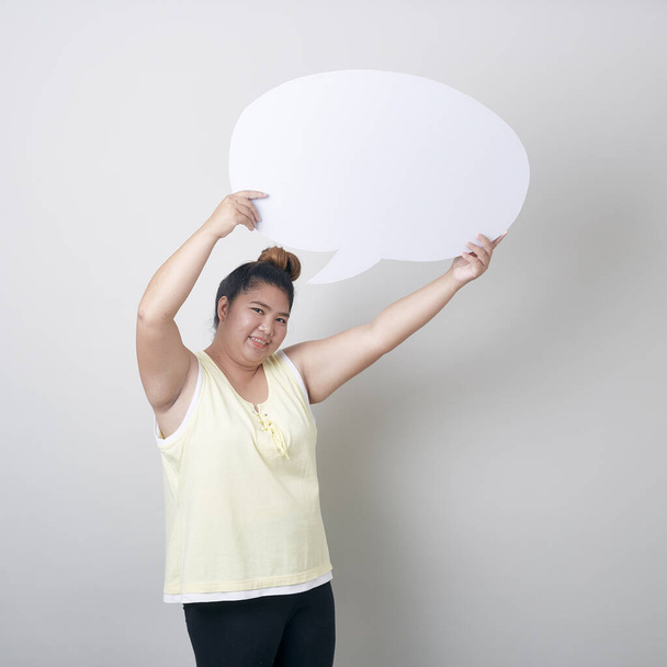 portrait of smiling plump asian woman with speech bubble with empty space for text studio shot isolated standing against light gray Banner background - Photo, Image