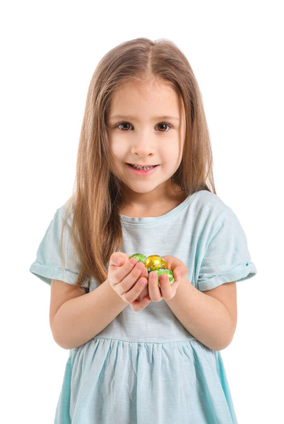 Cute little girl with sweet chocolate eggs on white background - Fotografie, Obrázek