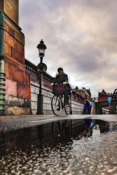 Stockholm, Sweden March 9, 2020 Bicyclist along a bike path at Riddarhuset. - Photo, Image