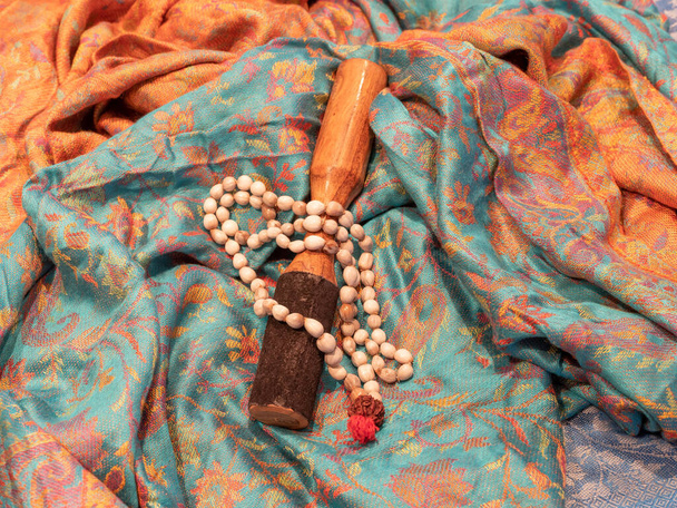 una collana indiana color ciottolo e un attaccante di legno su una sciarpa indiana
 - Foto, immagini