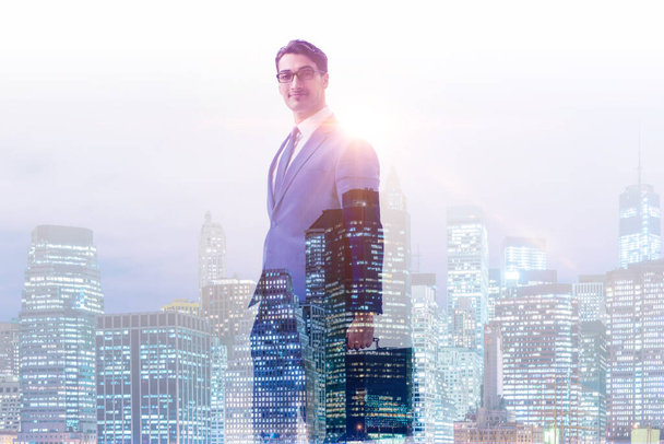 Successful businessman against cityscape in business concept - Photo, Image