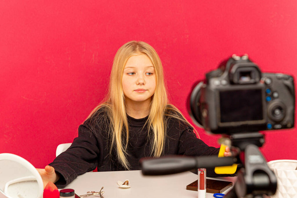 Happy girl at home speaking in front of camera for vlog. Teenager working as blogger, recording video tutorial for Internet. - Fotó, kép