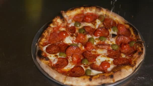 Hands of chef baker in uniform adding pepperoni into pizza. Pizza Art. The process of making pizza. - Video