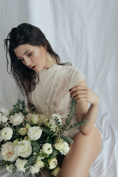 Girl with white roses and amaryllis on a white background - 写真・画像