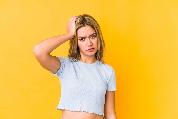 Young blonde caucasian woman isolated on a yellow background being shocked, she has remembered important meeting. - Foto, imagen