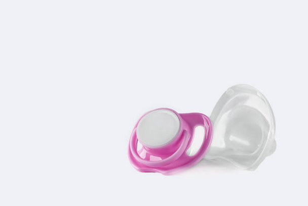 Pink baby's pacifier isolated on white background. Copy space. - 写真・画像