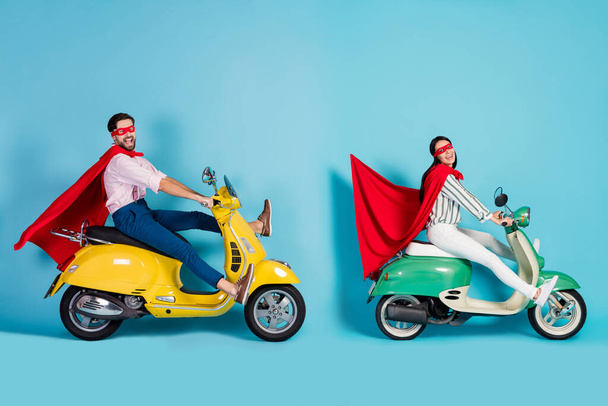 Full size profile photo of excited lady guy drive two retro moped big speed brakes stop wear red cape mask play party super hero role coat fly air isolated blue color background - Fotó, kép