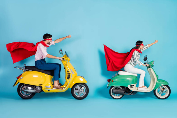 Full body profile photo of crazy lady guy drive two vintage moped raise fists wear red cape mask rushing road party super heroes role coat flying air isolated blue color background - Fotó, kép