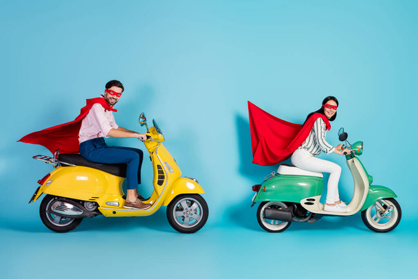 Full body profile photo of crazy lady guy drive two vintage moped wear red cape mask rushing road party play super heroes role coat flying air isolated blue color background - Valokuva, kuva