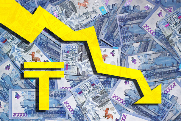 Laid out on the surface of 20,000 tenge banknotes with a tenge symbol and a down arrow. Devaluation of tenge concept - Foto, immagini
