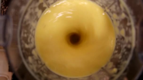 the blender creates a swirl of orange juice - Video