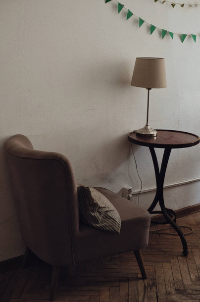 Retro interior fragment with armchair, table and lamp - Photo, image