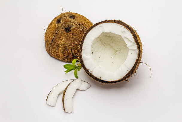 Ripe coconut cut on two half isolated on white background. Fresh fruit, ingredient for cooking food or beauty self care - Fotografie, Obrázek