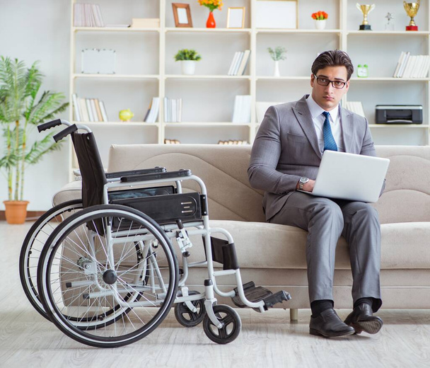 Dsabled businessman on wheelchair working home - Photo, Image