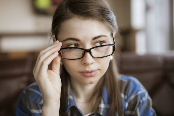 Myopia, woman try on optical eyeglasses - Foto, immagini