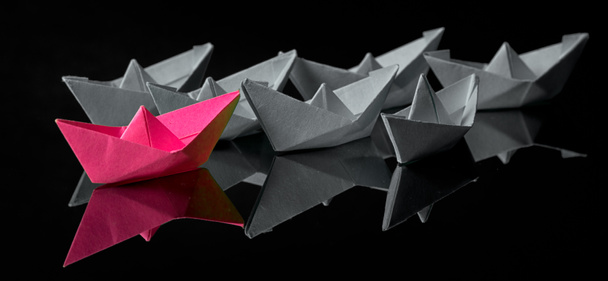 Origami paper ship with sailboats, leadership, marketing concept, social media influencers, HR recruiter, disruptive innovation, standing out concept. - Photo, Image