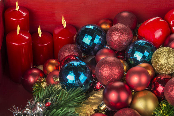 Christmas and New Year decoration balls  and candels on red background - Photo, Image