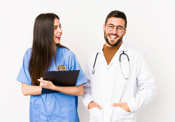 Young doctor man and a nurse isolated laughing and having fun. - Photo, Image