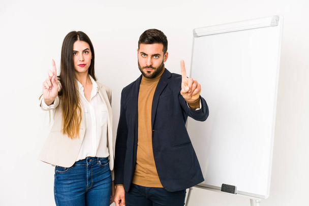 Young caucasian business couple isolated showing number one with finger. - Photo, Image