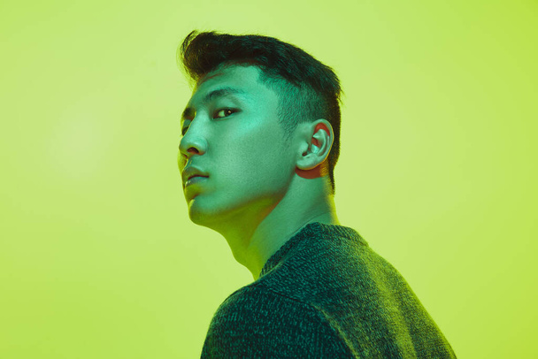 Portrait of a guy with colorful neon light on yellow background - cyberpunk concept - Photo, image