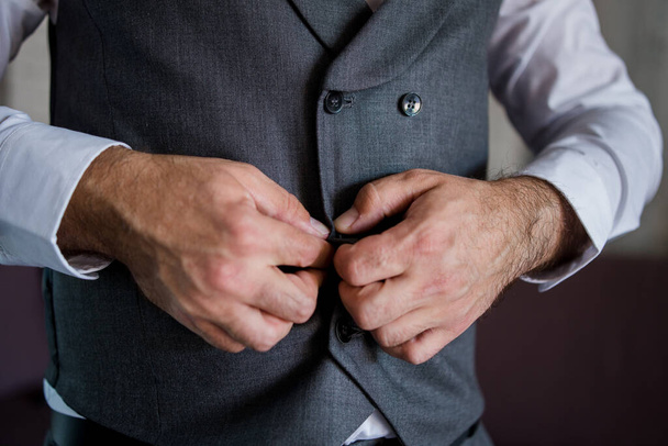man puts on a suit - Фото, изображение