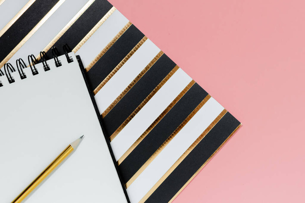 Mockup planner flat lay, top horizontal view pink background. Notepad and notebooks with stationary. Golden, white, pink and black colors - Φωτογραφία, εικόνα