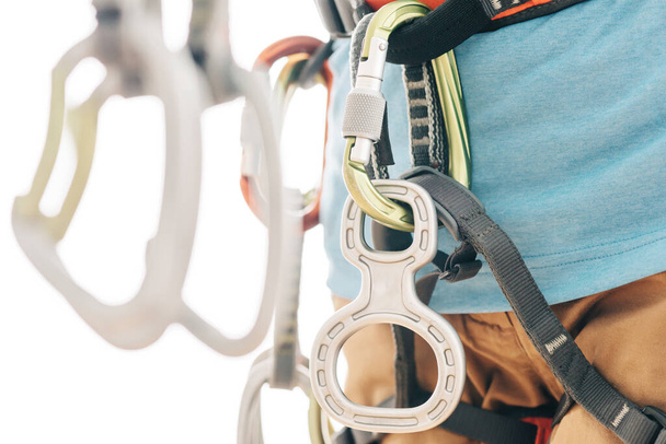 Close-up de desportista alpinista em arnês de segurança com equipamento de alpinismo segurando quickdraw
. - Foto, Imagem