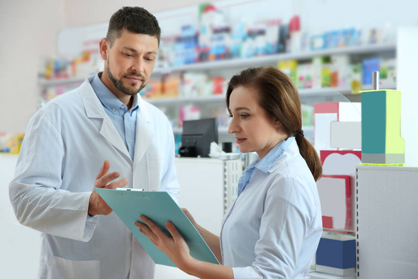 Portrait of professional pharmacists in modern drugstore - 写真・画像
