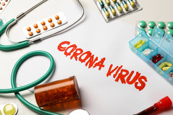 Phrase CORONA VIRUS and medicines on white background - Photo, image