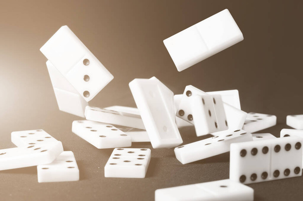 Fallen dominoes chips. Conceptual business or sport illustrative ides. Color shaded tint. - Photo, Image