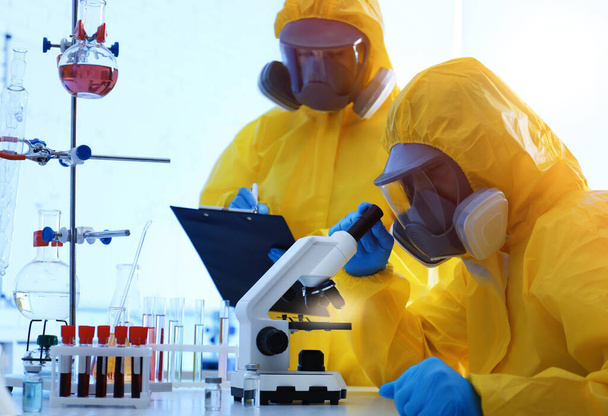 Vědci v chemických ochranných oblecích pracují v laboratoři. Virus research - Fotografie, Obrázek
