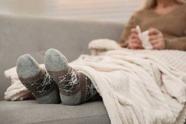 Mature woman and cold remedies on sofa, closeup. Dangerous virus - Фото, зображення