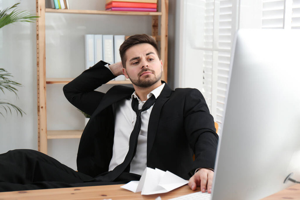 Lazy employee resting at table in office - Photo, Image
