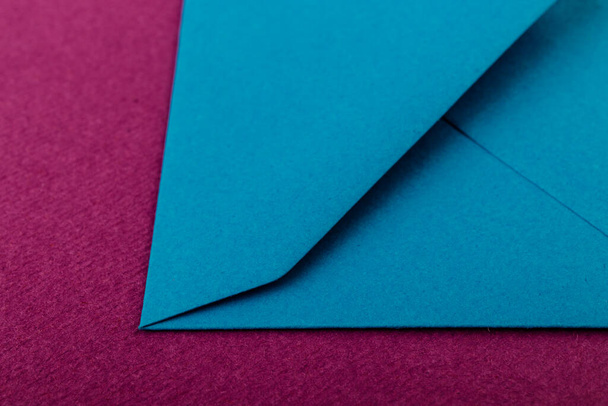 Colorful envelope on a purple background. Mail envelope on the table. - Zdjęcie, obraz