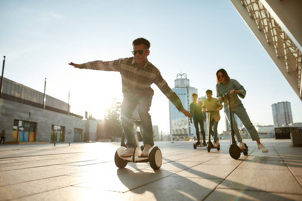 Born to Ride. A group of friends using kick scooters and segways on a sunny day - Photo, image