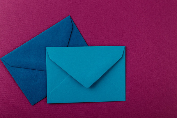 Colorful envelopes on a purple background. Mail envelopes on the table. - 写真・画像