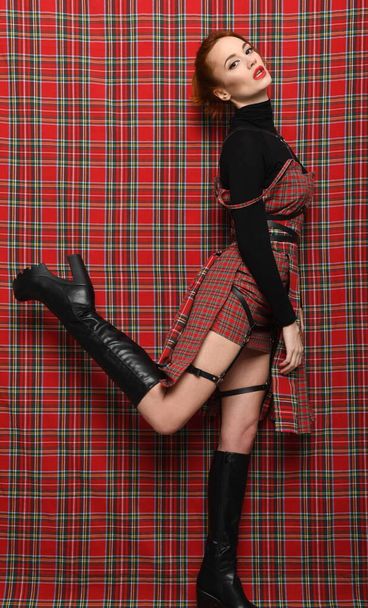 Modern fashion. A girl in a checkered dress  - Foto, Imagem