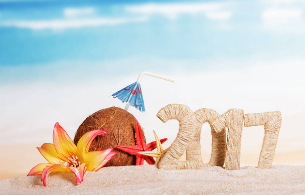 Sunny beach with an inscription 2017 Christmas coconut and starfish on sea background - Φωτογραφία, εικόνα