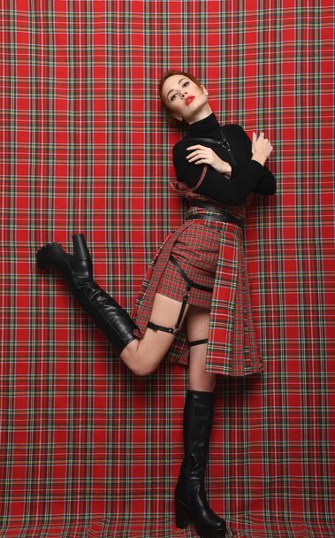 Modern fashion. A girl in a checkered dress  - Photo, Image