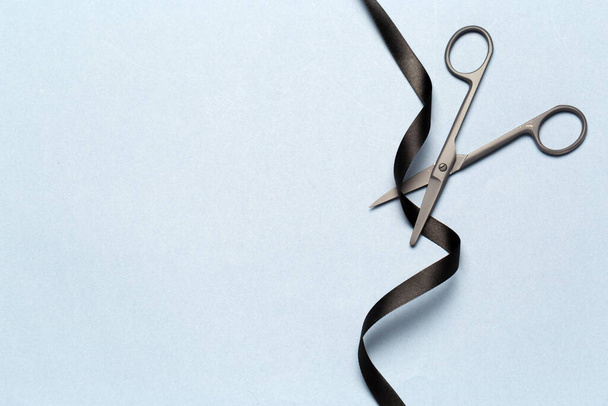 Grand Opening illustrated with scissors and a black ribbon on a gray background - Fotografie, Obrázek