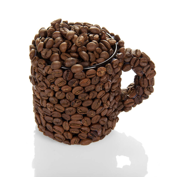 Cup of coffee beans filled with coffee beans isolated on white background. - 写真・画像