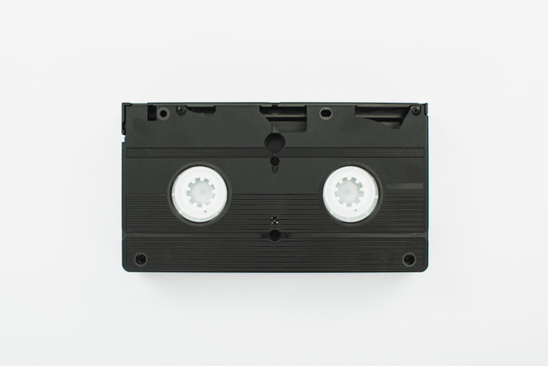 top view of black VHS cassette on white background - Foto, afbeelding