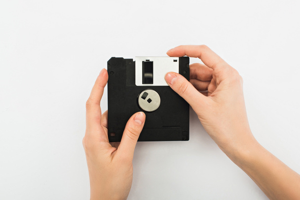 partial view of man holding diskette on white background - Foto, imagen