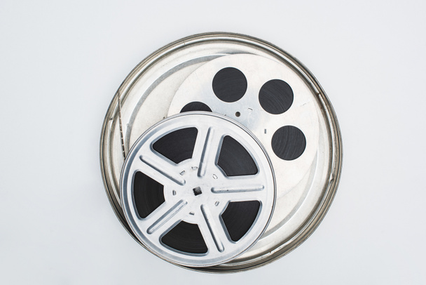 top view of film reels with film strip in tin case on white background - Photo, Image