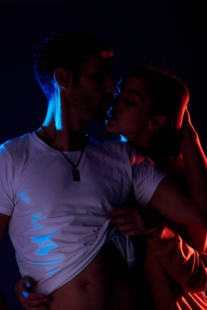 Portrait of sexy young male and female models hugging passionately - Photo, image