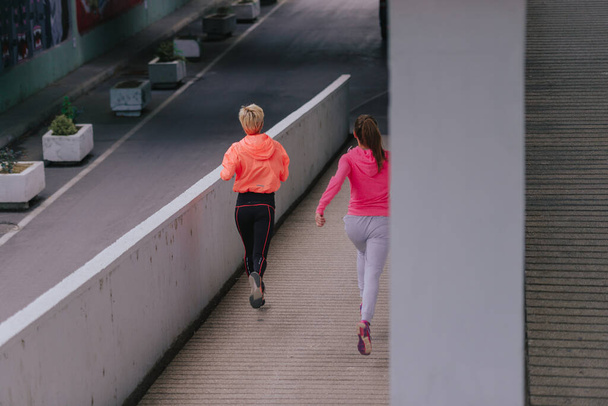 Healthy lifestyle athletes dressed in training clothes exercising - Photo, Image