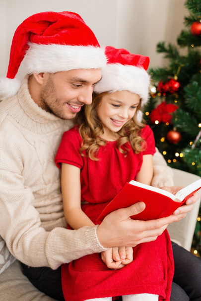 Smiling father and daughter reading book - Foto, Imagen