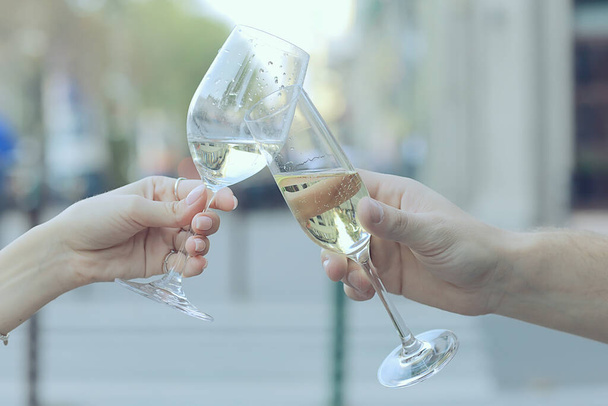 glasses of toast chin chin, hands with glasses of white wine in a street cafe - Photo, image