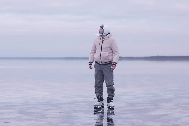 one guy skates on the ice of a frozen lake, nature landscape, man outdoor sports - Fotó, kép