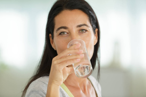 picture of woman drinking water from glass - Fotó, kép